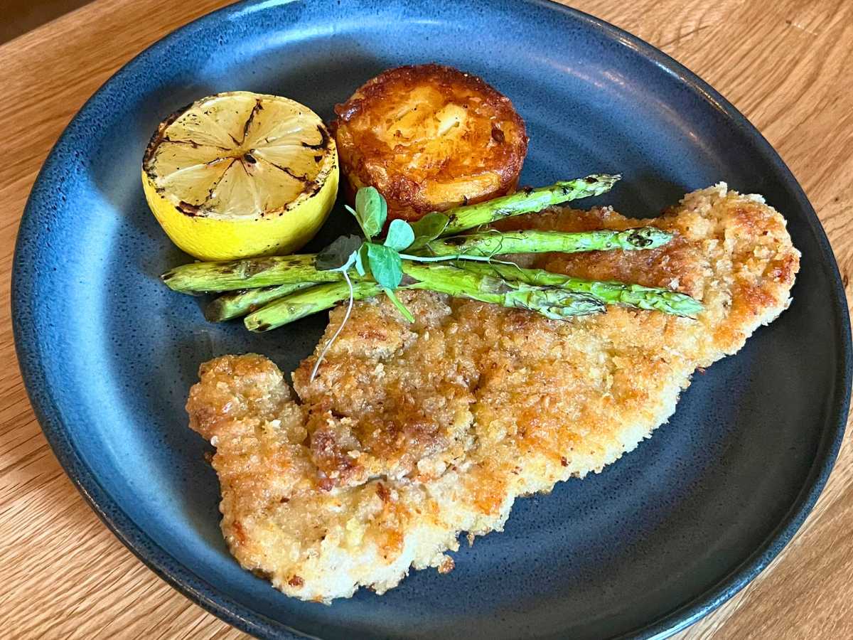 Tender Penllyn Estate pork escalope served with garlic butter and grilled asparagus – a fresh, seasonal recipe from Forage Farm Shop & Kitchen.